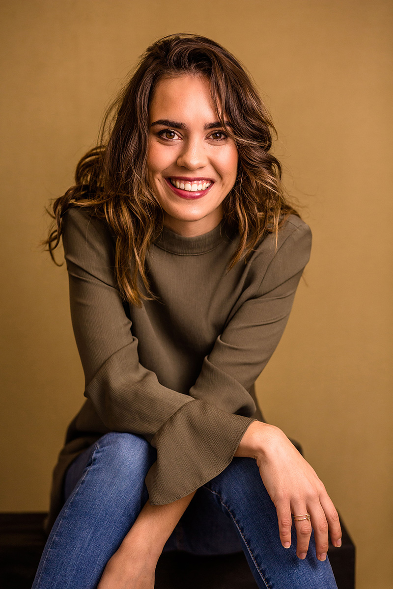 A business owner seated, smiling to camera