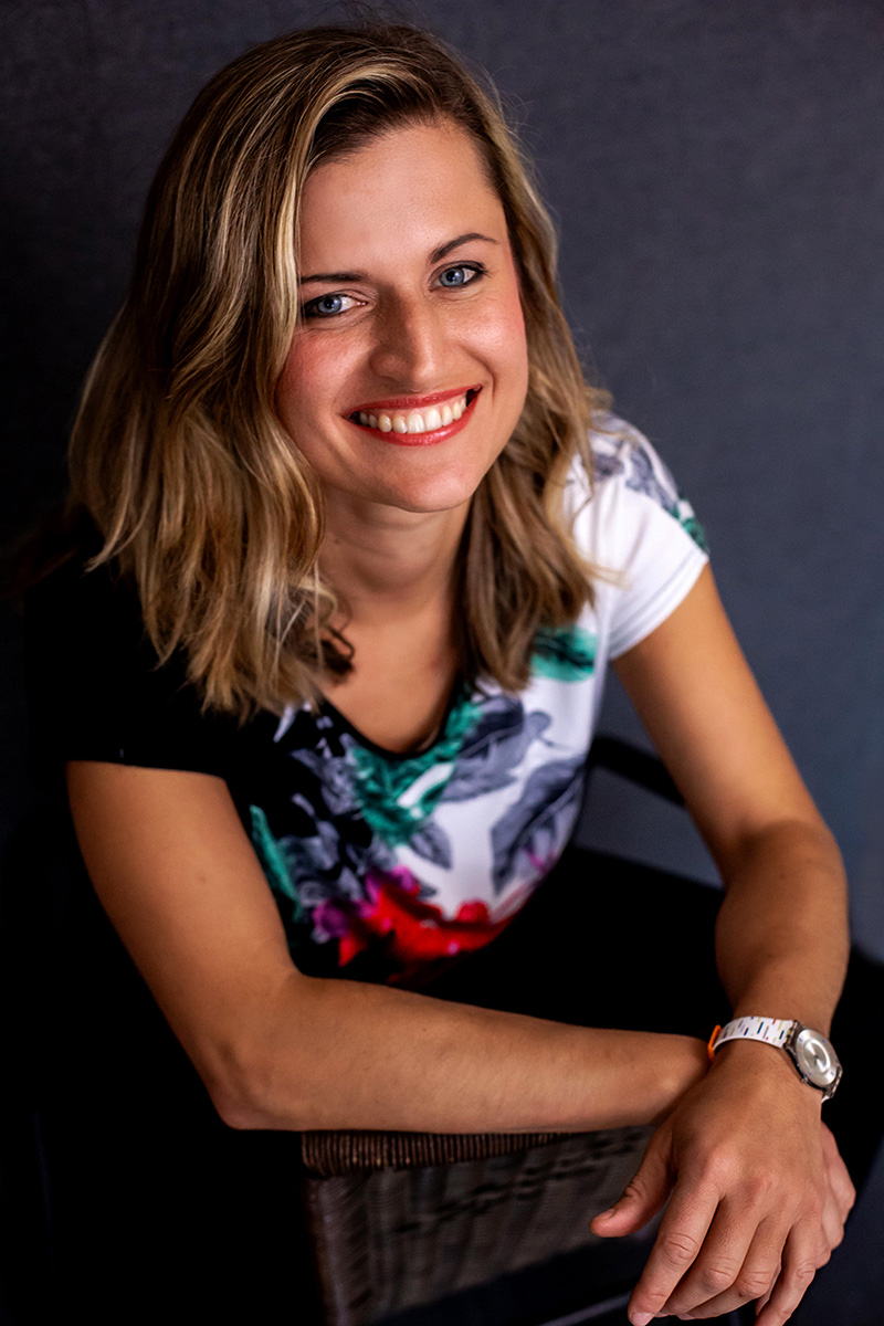 A smiling client wearing a floral headpiece