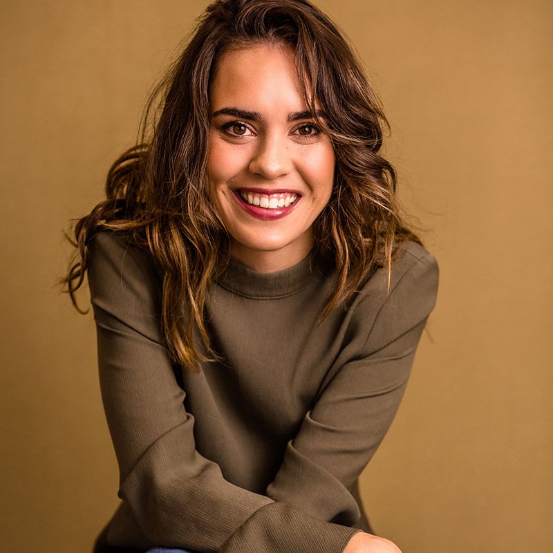 A business owner seated, smiling